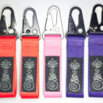 Unalome 1 inch Keychains in various colors.